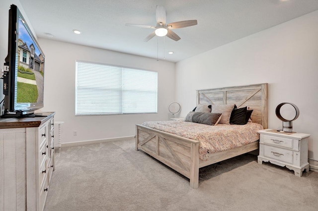 bedroom with recessed lighting, baseboards, light colored carpet, and ceiling fan