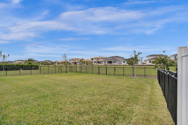 view of yard with fence and a residential view