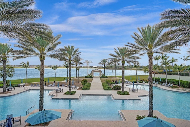 community pool featuring a patio area and a water view