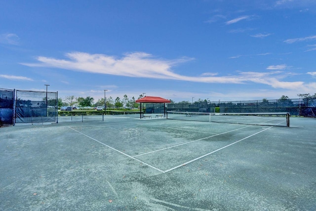 view of tennis court with fence