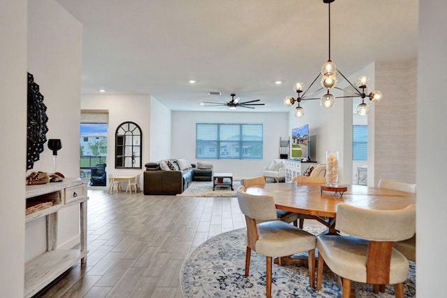 dining room featuring visible vents, recessed lighting, ceiling fan with notable chandelier, and wood finished floors