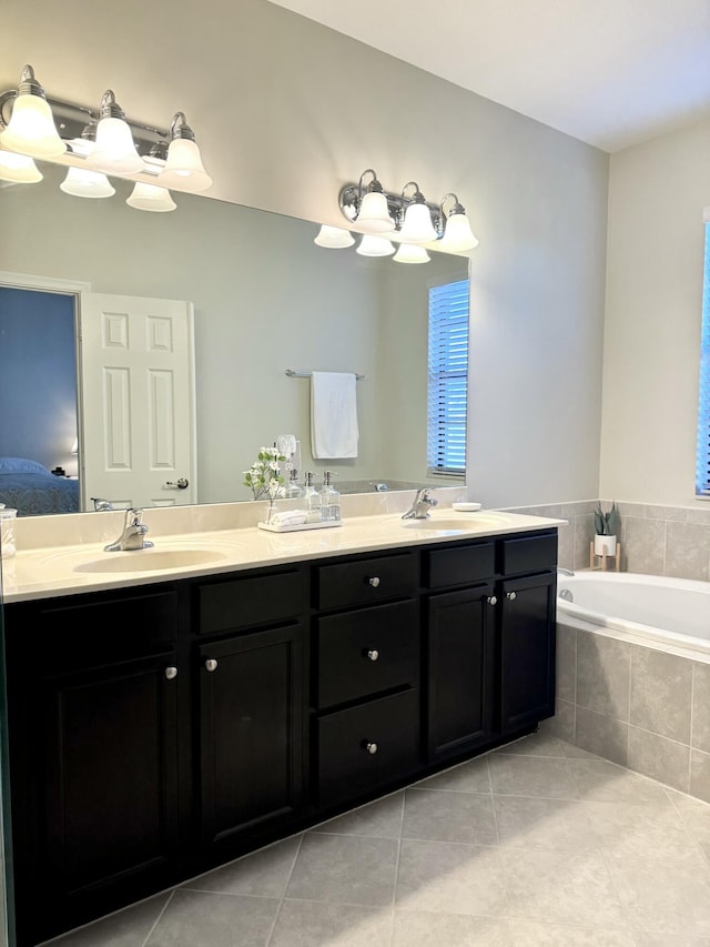 bathroom with tile patterned floors, double vanity, a sink, and ensuite bathroom