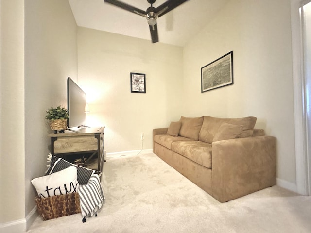 carpeted living area featuring ceiling fan and baseboards