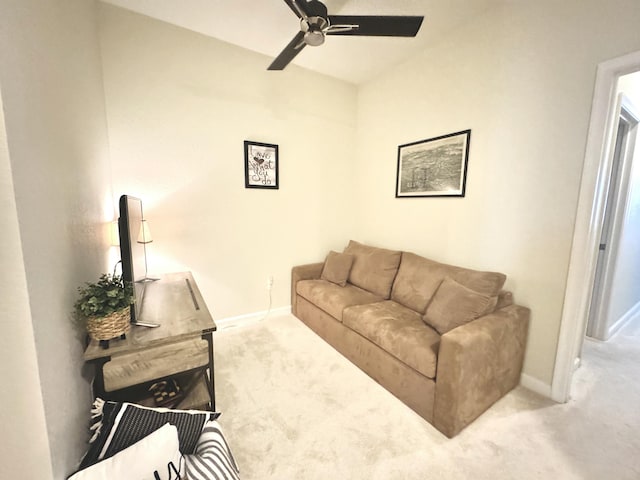 living room featuring ceiling fan, carpet, and baseboards