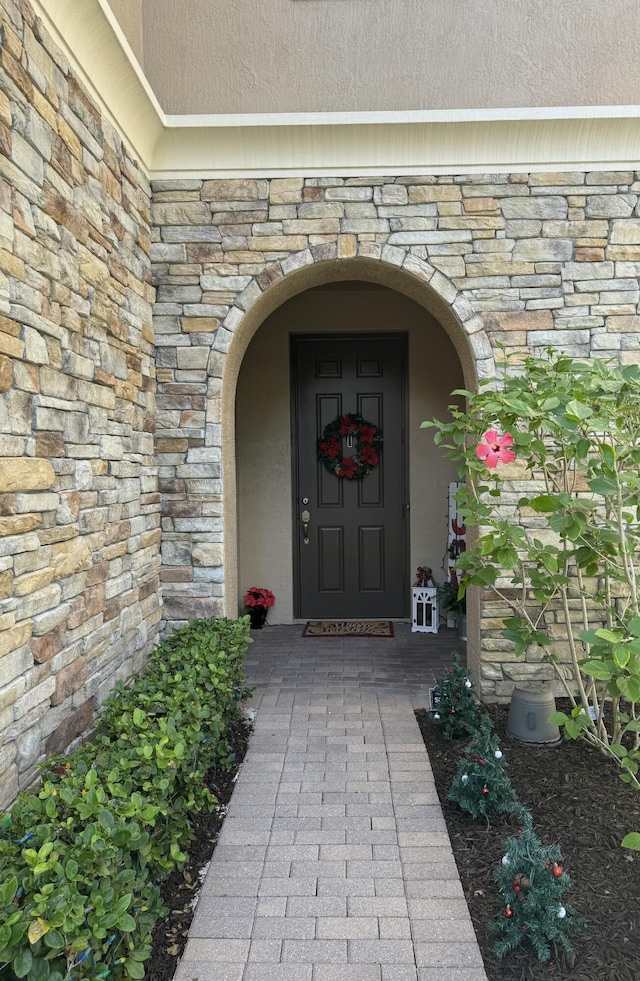 entrance to property featuring stone siding