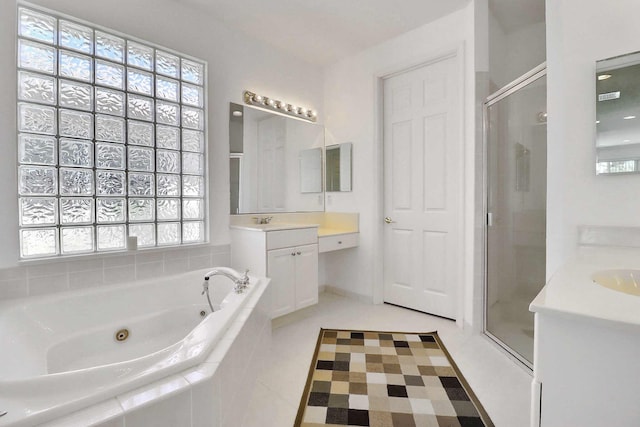 bathroom featuring tile patterned flooring, a jetted tub, a stall shower, and vanity