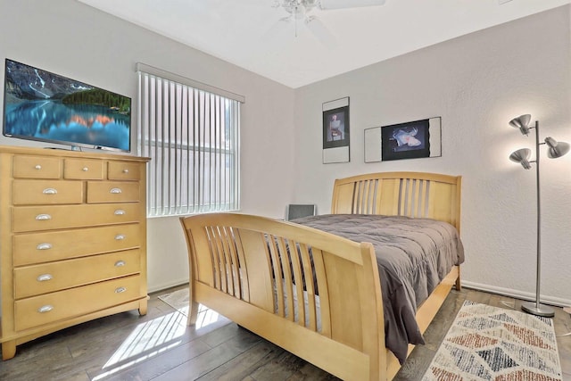 bedroom featuring a ceiling fan, wood finished floors, and baseboards