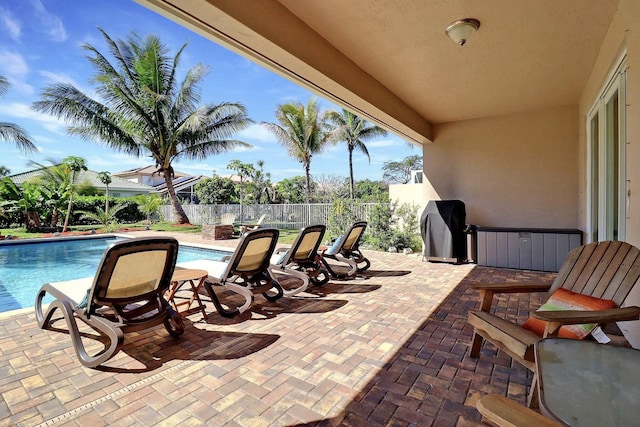 view of patio featuring a fenced in pool, a grill, and a fenced backyard