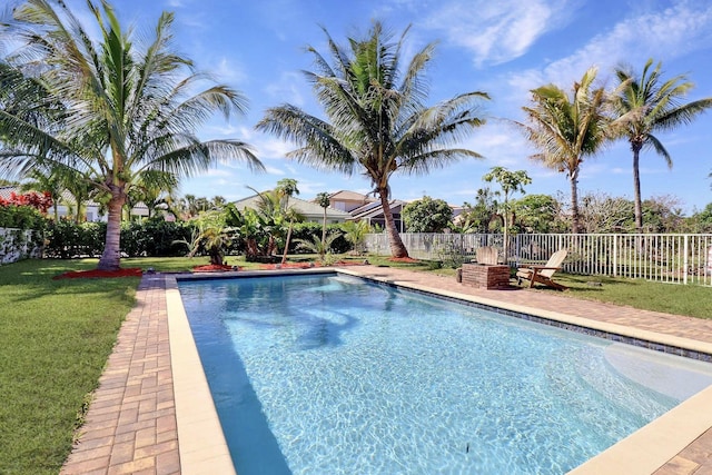 view of swimming pool with a lawn, a patio, a fenced backyard, and a fenced in pool