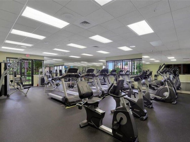 exercise room with a paneled ceiling and visible vents