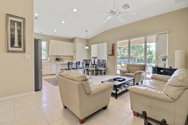 living room with light tile patterned floors, visible vents, baseboards, and lofted ceiling