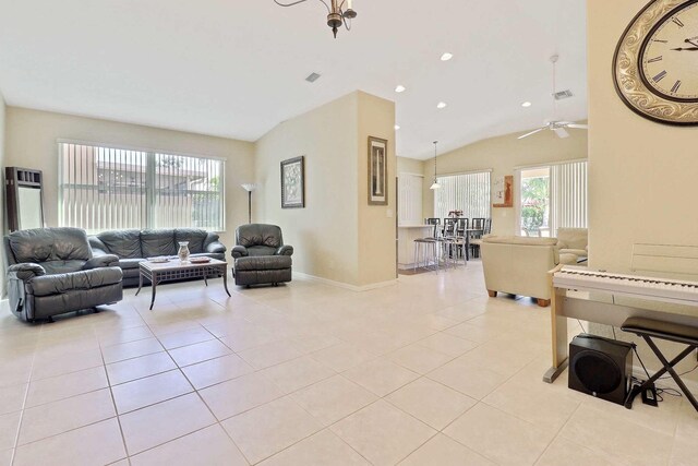 living area with lofted ceiling, light tile patterned floors, baseboards, and visible vents