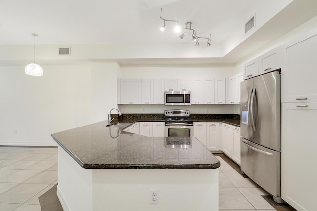 kitchen with light tile patterned floors, visible vents, and stainless steel appliances