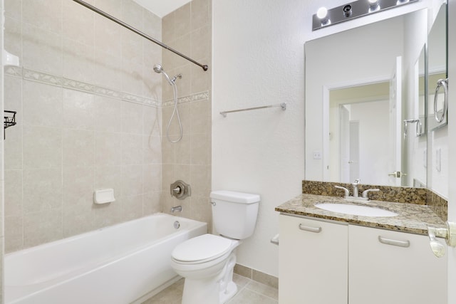 bathroom featuring toilet, tile patterned flooring, baseboards, bathtub / shower combination, and vanity