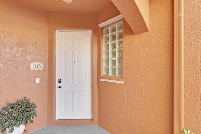 property entrance featuring stucco siding