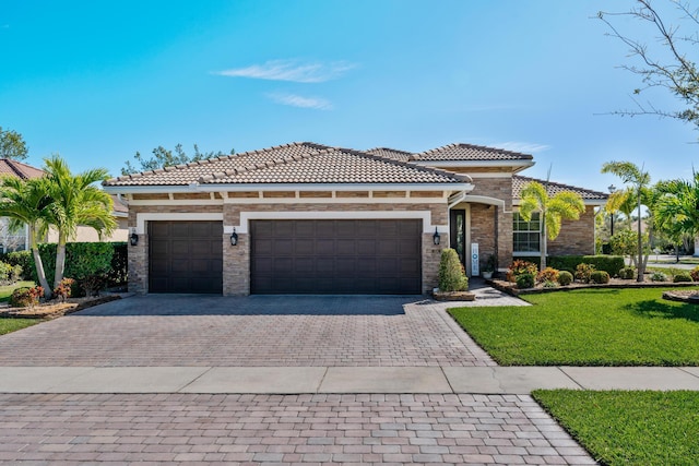 view of front facade featuring decorative driveway, stone siding, a garage, and a front lawn