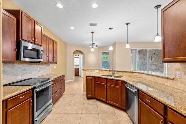 kitchen with light stone counters, light tile patterned floors, visible vents, a sink, and stainless steel appliances