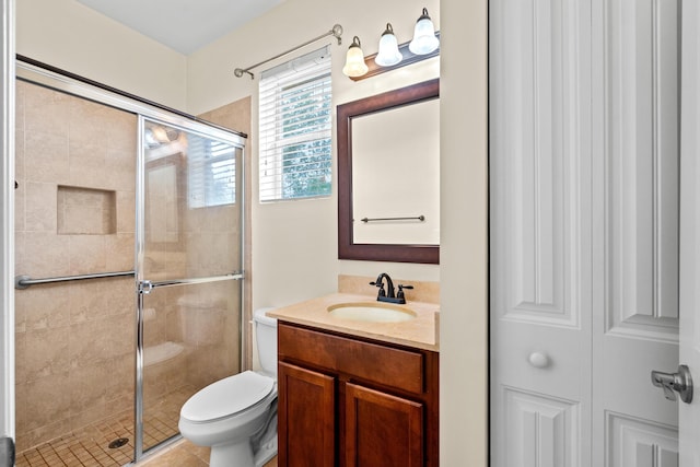 bathroom featuring vanity, toilet, and a stall shower