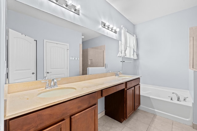 full bath featuring tile patterned flooring, double vanity, a bath, and a sink