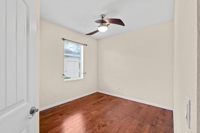 unfurnished room with baseboards, wood finished floors, and a ceiling fan