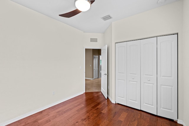 unfurnished bedroom with wood finished floors, visible vents, and baseboards