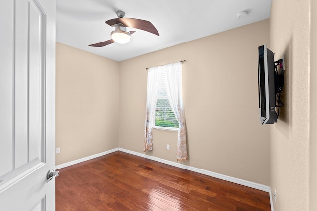 unfurnished room with ceiling fan, baseboards, and wood finished floors