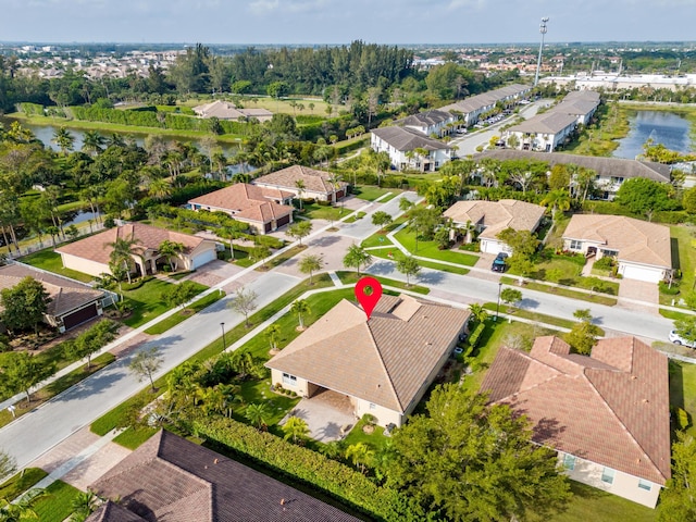 birds eye view of property featuring a residential view and a water view