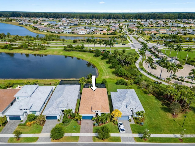 birds eye view of property with a residential view and a water view