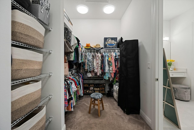 spacious closet with carpet flooring