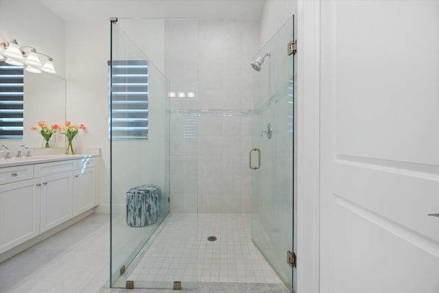 bathroom with a shower stall, vanity, and tile patterned floors