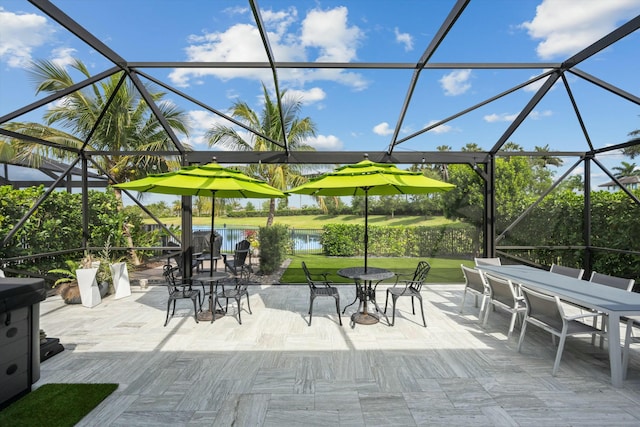 view of patio / terrace with outdoor dining area and a lanai