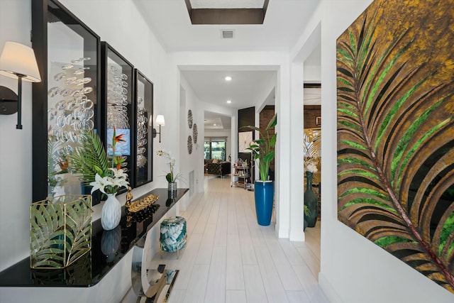 corridor with recessed lighting, visible vents, and wood finished floors