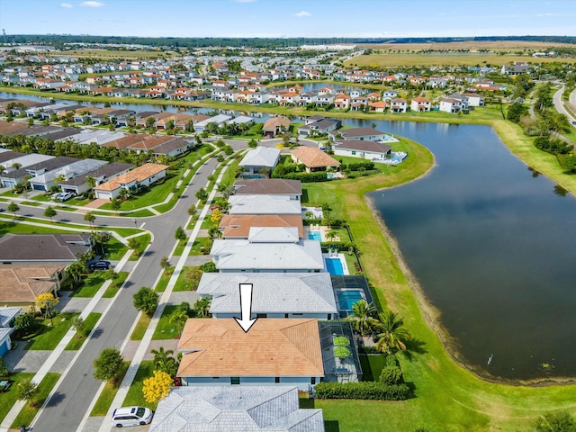 drone / aerial view featuring a residential view and a water view