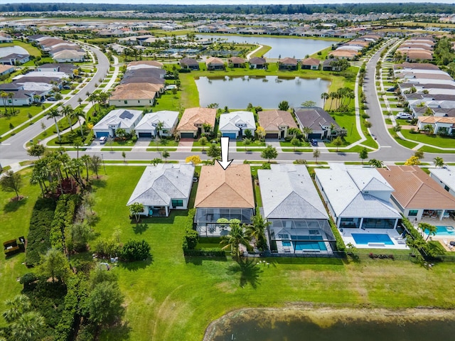 drone / aerial view featuring a residential view and a water view