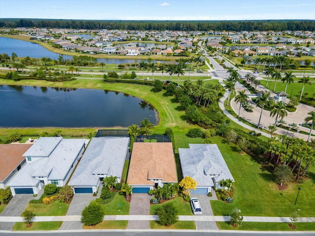 drone / aerial view with a water view and a residential view