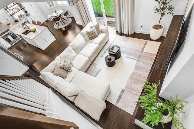 living room with baseboards and wood finished floors