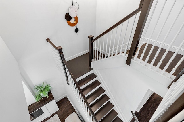 stairway featuring wood finished floors and baseboards