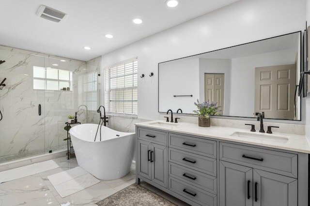 bathroom featuring a marble finish shower, visible vents, marble finish floor, and a sink