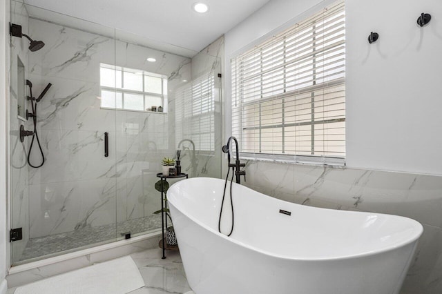 bathroom with recessed lighting, a marble finish shower, a soaking tub, and marble finish floor