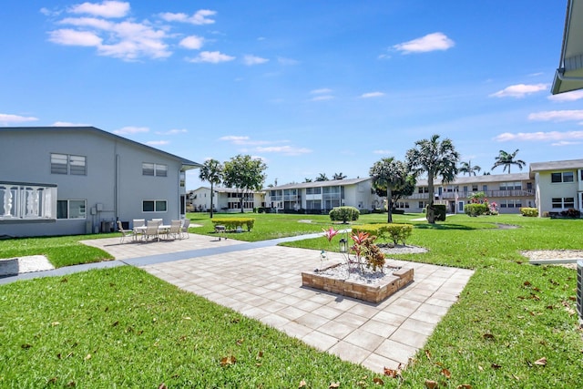 view of yard featuring a residential view and a patio