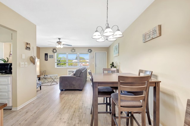 dining space featuring ceiling fan with notable chandelier, light wood-style flooring, and baseboards