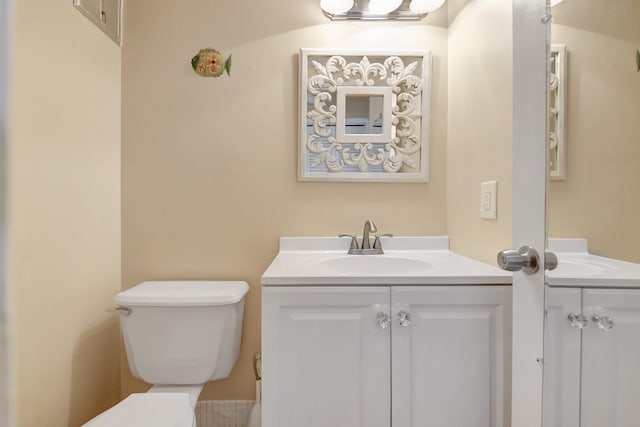 bathroom with toilet and vanity