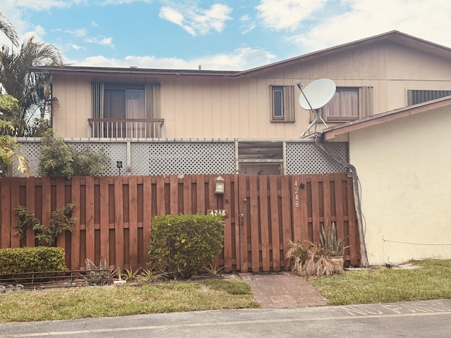 view of side of property featuring fence