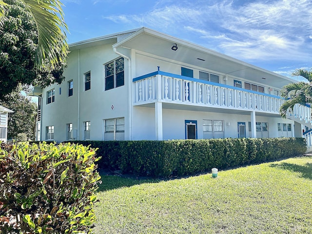 view of home's exterior with a yard and stucco siding