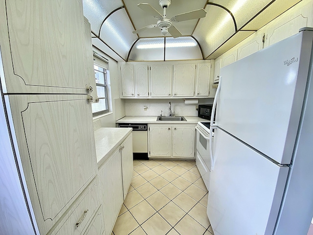 kitchen featuring light tile patterned floors, light countertops, ceiling fan, a sink, and white appliances