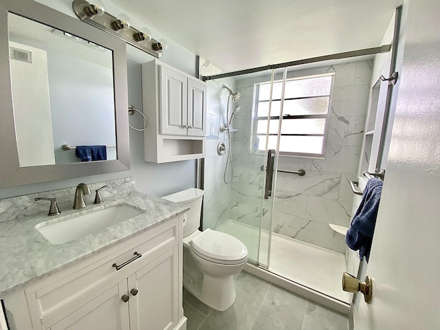 bathroom with visible vents, toilet, vanity, and a marble finish shower