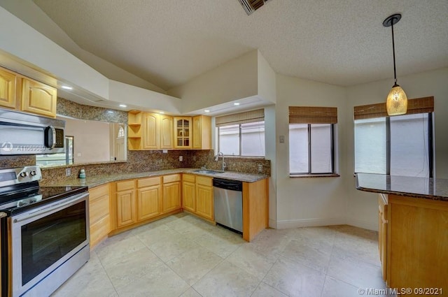 kitchen featuring visible vents, a sink, lofted ceiling, stainless steel appliances, and open shelves