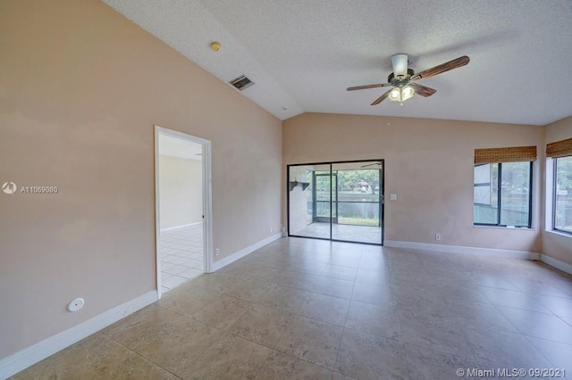 unfurnished room with visible vents, baseboards, lofted ceiling, a textured ceiling, and a ceiling fan