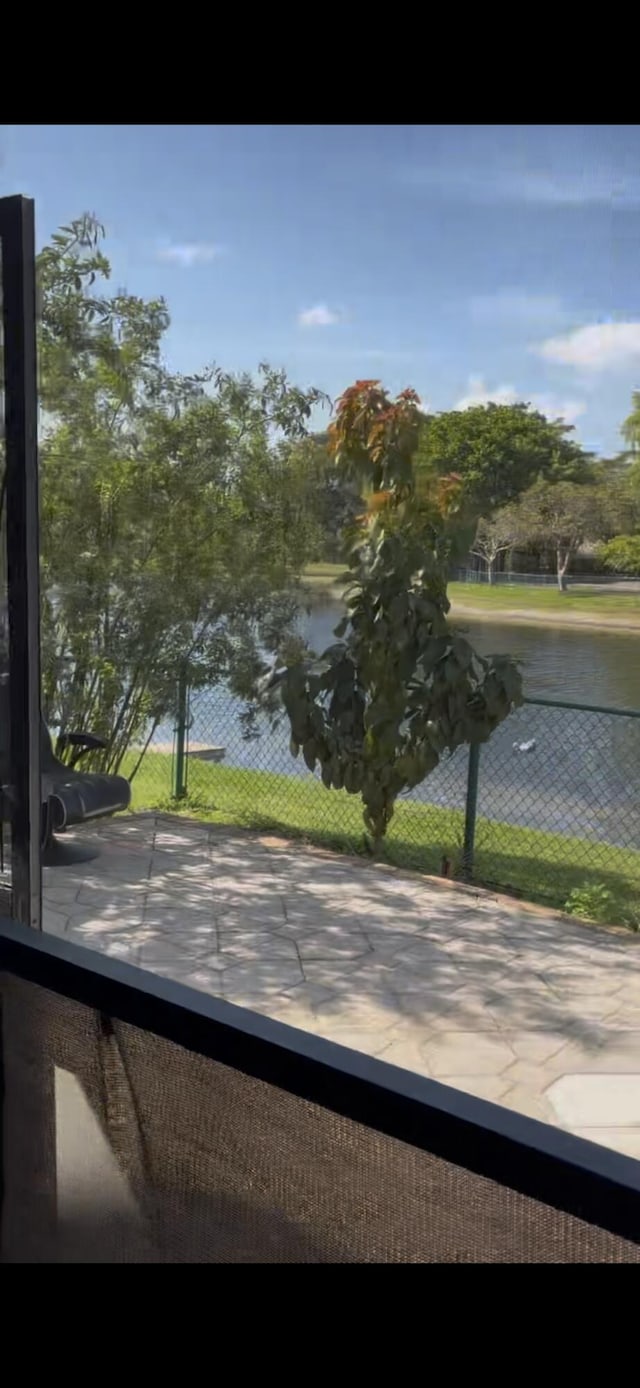 property view of water featuring fence