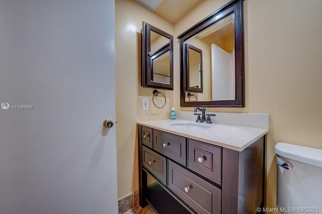 bathroom featuring vanity and toilet